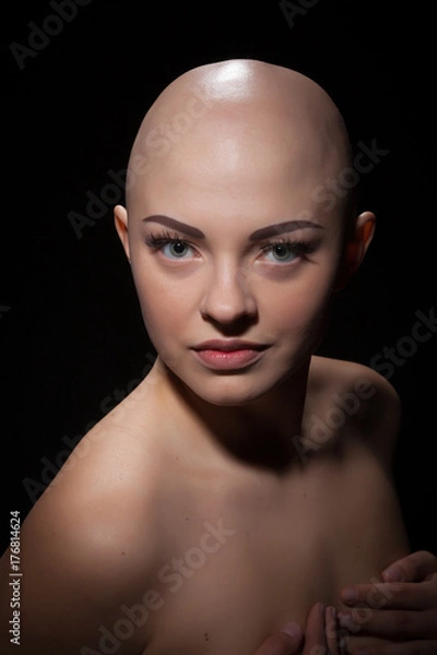 Obraz Portrait of a bald girl on a black background.