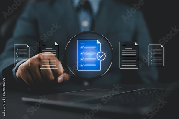 Fototapeta Businessman analyzing documents with magnifying glass and check mark icon, representing document verification, quality assurance, compliance review, and data validation process.