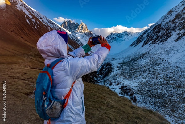 Obraz Asian woman taking photo of  snowy at caucasus mountains in georgia