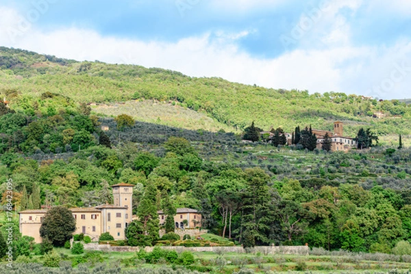 Obraz Stunning view of rolling hills with olive groves and historic buildings in Tuscany, Italy