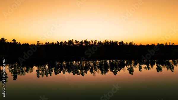 Fototapeta Golden Hour Reflection on a Calm Lake
