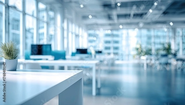 Fototapeta Bright, modern office space with desks, computers, and large windows