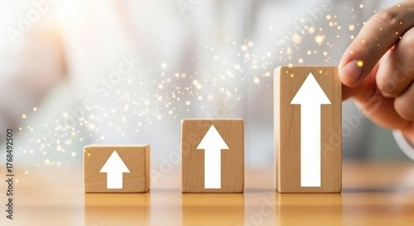 Fototapeta Wooden blocks with white arrows show business growth and investment success