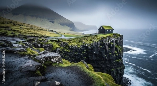 Fototapeta Isolated green grass covered house perched precariously on a dramatic cliff overlooking a stormy sea