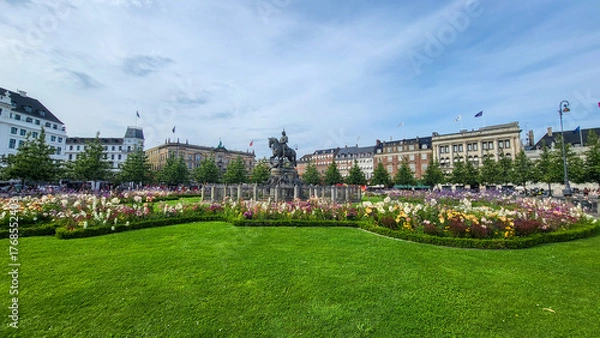 Fototapeta 07 August, 2024, Copenhagen city center, Denmark Summer day scenic canal with boats and tourists, cyclists riding along colorful buildings and waterfront, vibrant urban atmosphere in European capital