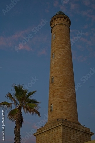 Obraz lighthouse in Chipiona in Andalusia in warm blue light after sunset