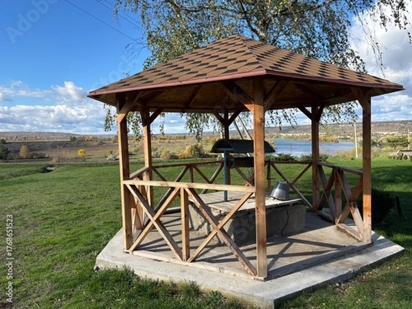 Fototapeta Beautiful autumn park filled with golden-yellow trees, cozy benches, and winding walking paths. Fallen leaves cover the ground, creating a peaceful and romantic atmosphere perfect for relaxation