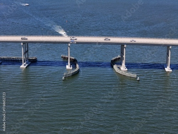 Fototapeta Aerial View Of Washington Baum Bridge Over Calm Water of Roanoke Sound Connecting Roanoke Island to Nags Head on the Outer Banks. Bright blue sky, tranquil water, urban-seaside scene.