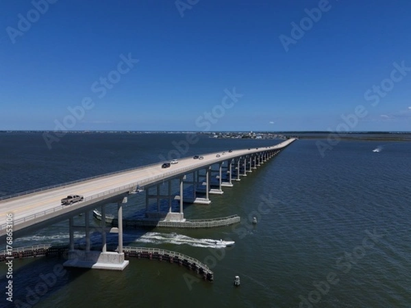 Fototapeta Aerial View Of Washington Baum Bridge Over Calm Water of Roanoke Sound Connecting Roanoke Island to Nags Head on the Outer Banks. Bright blue sky, tranquil water, urban-seaside scene.
