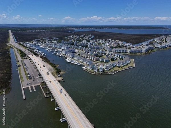 Fototapeta Aerial View Of Washington Baum Bridge Over Calm Water of Roanoke Sound Connecting Roanoke Island to Nags Head on the Outer Banks. Bright blue sky, tranquil water, urban-seaside scene.