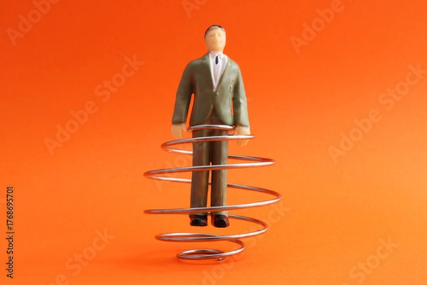 Obraz Executive trapped in metal spiral, escaping conflicts