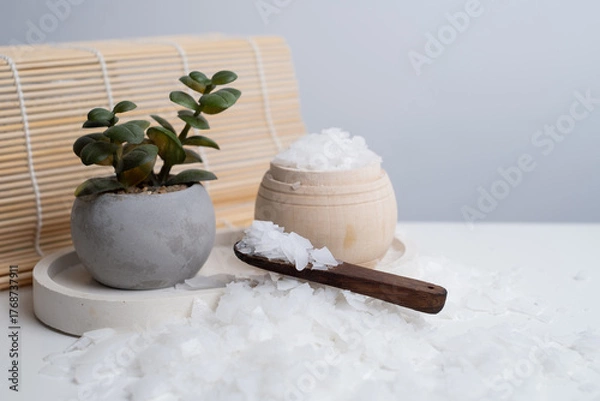 Obraz Close-up of magnesium salt flakes. Spa body care and magnesium therapy. White salt, cotton towels, eco-friendly products for home relaxation spa.
