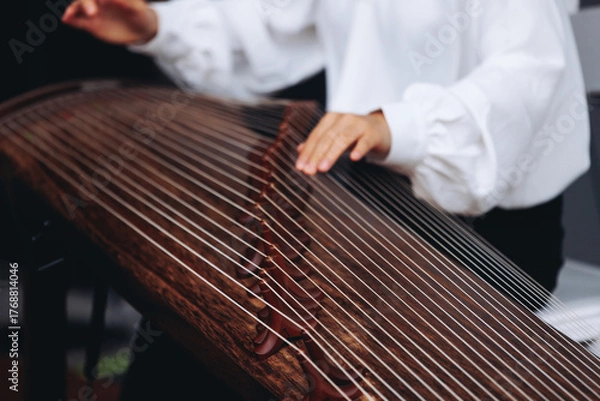 Fototapeta Traditional Korean folk musical instrument Gayageum, female orchestra band performing concert on Kayagum in of Seoul, South Korea, wooden zither with 12 strings, Koto or Guzheng live music performance