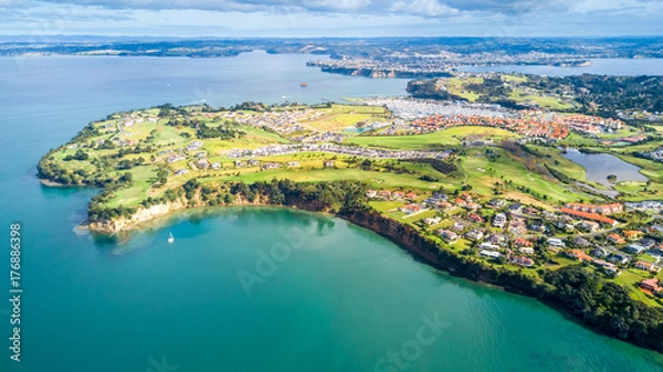 Obraz Aerial view on residential suburbs surrounded by sunny ocean harbour. Whangaparoa peninsula, Auckland, New Zealand