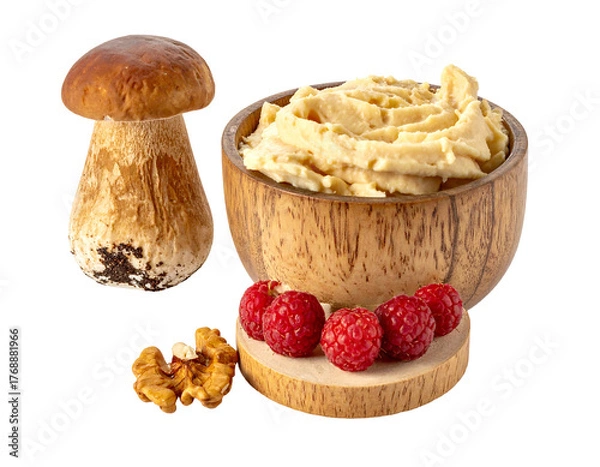 Fototapeta Still life mushroom, creamy spread in wooden bowl, raspberries, walnut. Isolated on black background