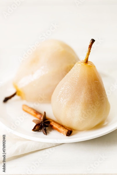 Obraz Poached pears with spices in syrup.