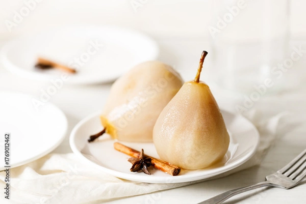 Obraz Poached pears with spices in syrup.