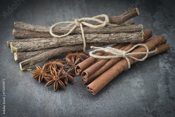 Fototapeta Star anise,cinnamon and licorice on grey background