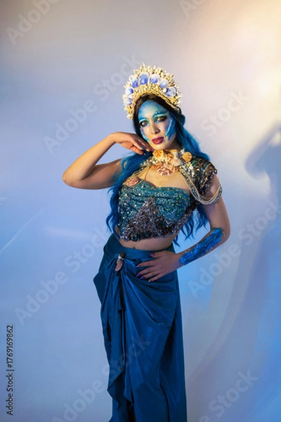 Fototapeta Attractive woman in a blue mermaid costume. Fantasy studio portrait of a mermaid model