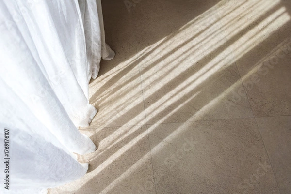 Fototapeta close up of white curtains and beige natural stone floor with sunlight pattern. soft fabric texture. natural materials. minimalist cozy