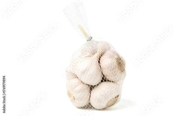Fototapeta Garlic is in a mesh bag. isolated on white background.