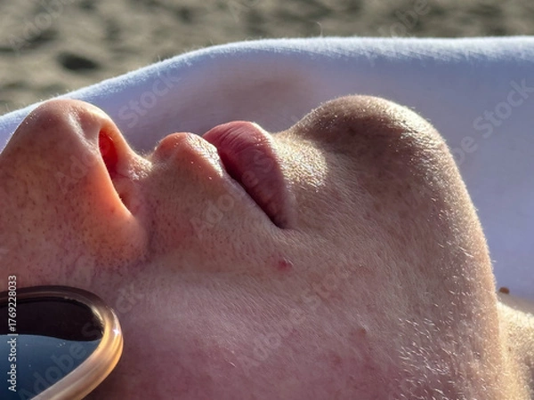 Fototapeta Closeup of person sunbathing with relaxed face