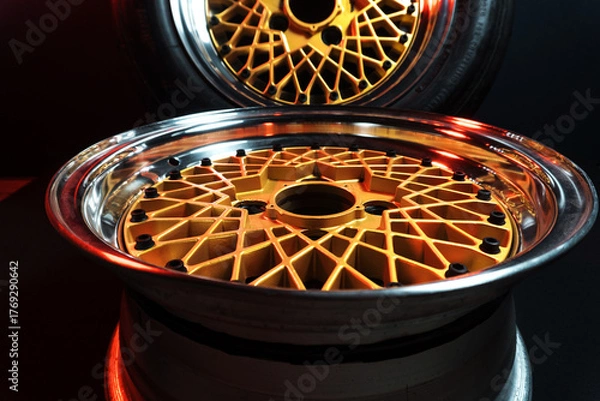 Fototapeta old retro stylish wheels collapsible two-component with a gold center and shiny rims for car tuning long exposure photo to simulate movement