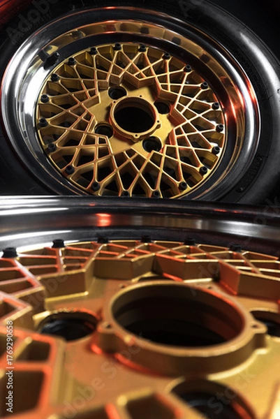 Fototapeta old retro stylish wheels collapsible two-component with a gold center and shiny rims for car tuning long exposure photo to simulate movement