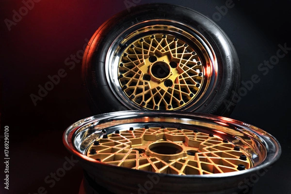 Fototapeta old retro stylish wheels collapsible two-component with a gold center and shiny rims for car tuning long exposure photo to simulate movement