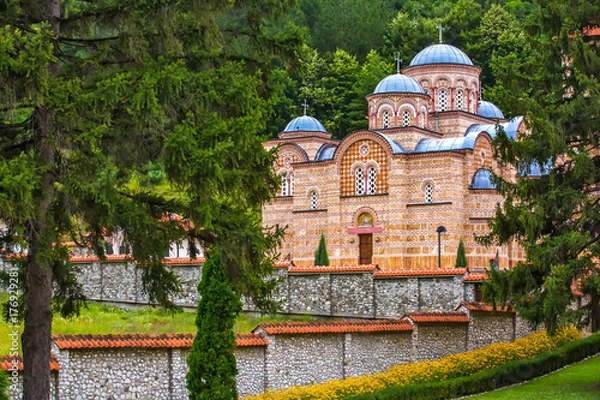 Fototapeta Orthodox church with a beautiful stone fence surrounded by fairy-tale nature, trees and mountain forest. Temple Trocrkva, Valjevo, Serbia.