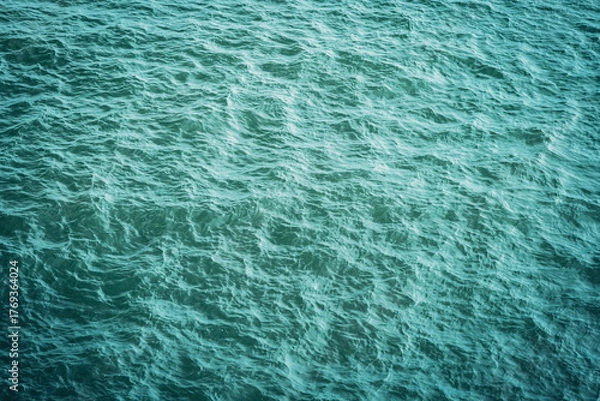Fototapeta Green or turquoise ocean water surface aerial view. Top down view, calm ocean waters and ripples, no people