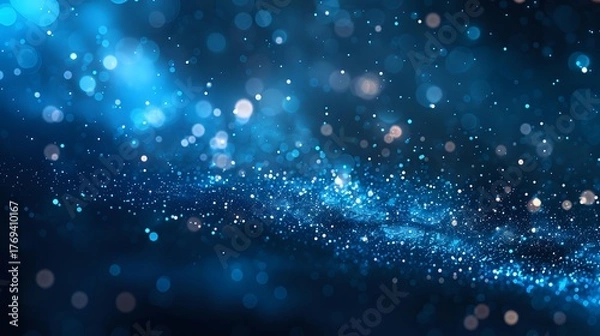 Obraz Magical blue bokeh lights and glowing particles floating in dark space create dreamy atmospheric background for festive designs and holiday projects.