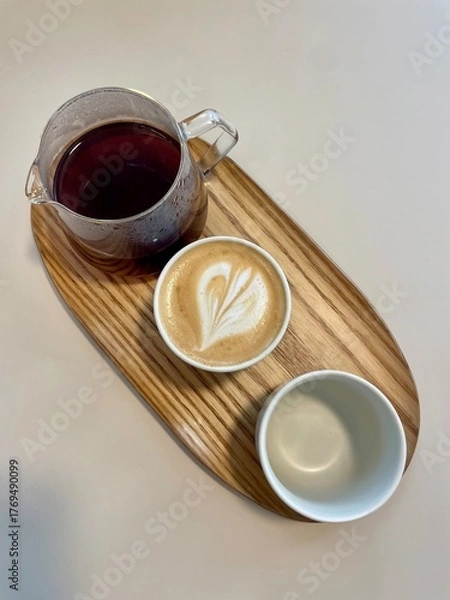 Fototapeta Filter coffee maker and cup of cappuccino on wooden table, cozy morning coffee scene.
