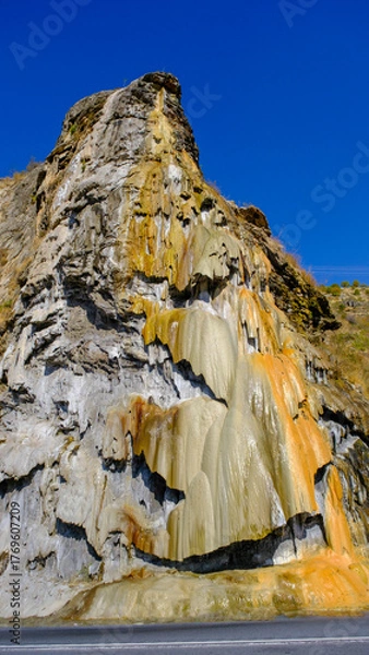Fototapeta travertine waterfall wide angel shot, with mineral waters, the waterfall turned into chalky and colorful travertines.