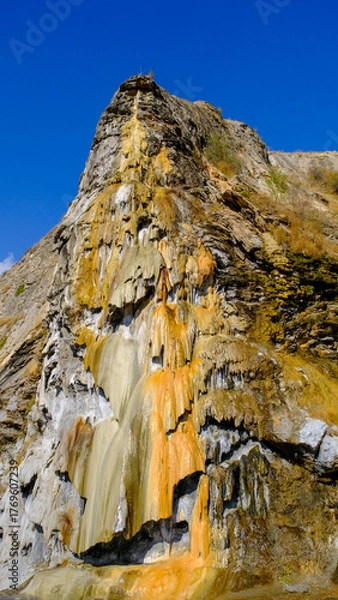 Fototapeta travertine waterfall wide angel shot, with mineral waters, the waterfall turned into chalky and colorful travertines.