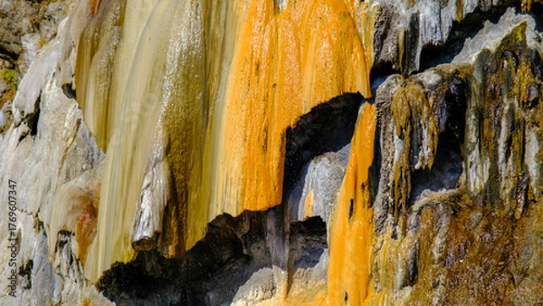 Fototapeta travertine waterfall close-up image, with mineral waters, the waterfall turned into chalky and colorful travertines.