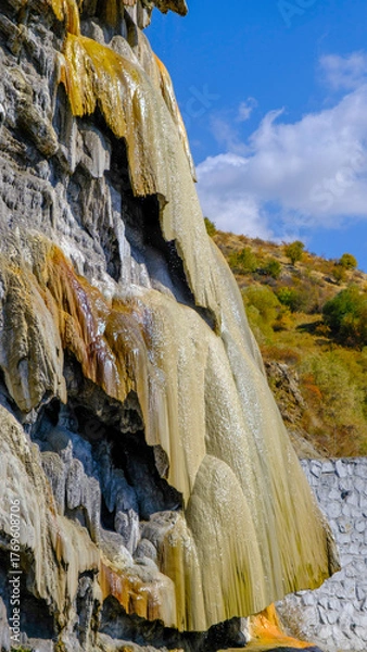 Fototapeta travertine waterfall wide angel shot, with mineral waters, the waterfall turned into chalky and colorful travertines.