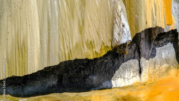 Fototapeta travertine waterfall close-up image, with mineral waters, the waterfall turned into chalky and colorful travertines.