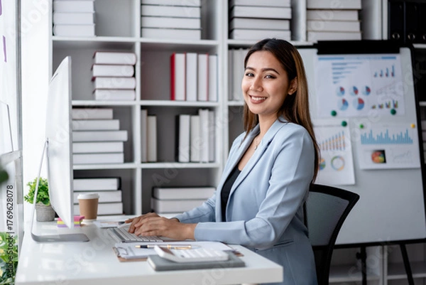 Fototapeta Accounting business concept, Accountant woman working on computer and calculator with paperwork of finance