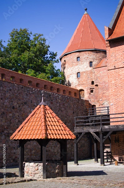 Fototapeta Historic brick castle with red roof and tower, Bytow, Poland