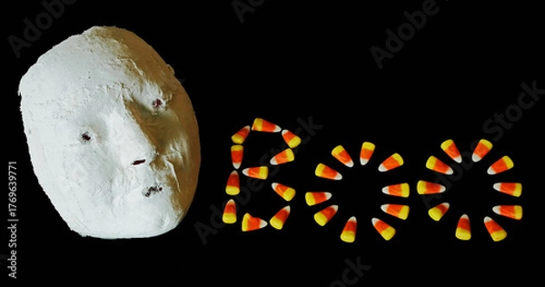 Obraz A Halloween mask and candy corn create an image for Autumn and Halloween