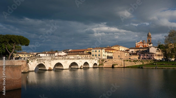Obraz Rimini, italian travel destination. Tiberio bridge, roman architecture. Historic center at sunset.