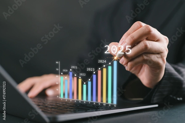 Fototapeta The 2025 New Year business goals concept. Businesswoman analysis graph of trend market growth in 2025 and plans business growth and profit increases. Financial data for long-term investments