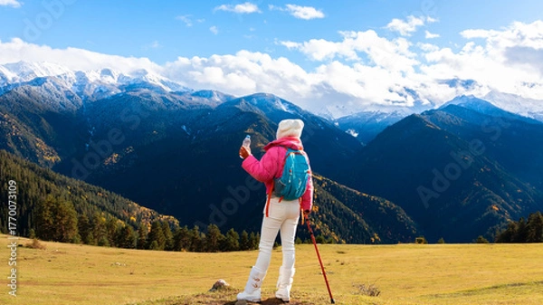Fototapeta Asian woman as her dog rest and enjoy of the view as sitting on a chair. Hiking in nature.  in Mestia Mountain ,Georgia