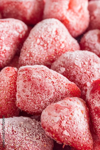 Fototapeta Pile of frozen strawberries for a background. Close-up