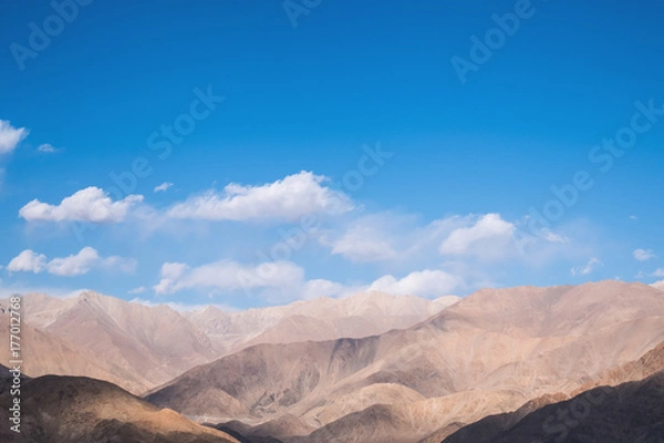 Fototapeta Closeup image of mountains and blue sky with clouds background in Ladakh , India