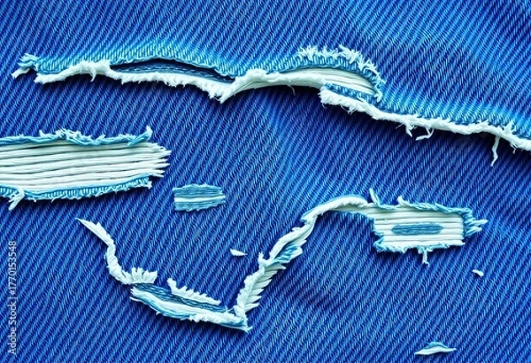 Obraz Close-up of distressed denim fabric with visible rips and frayed edges, showing texture and blue tones,  textile background,  frayed