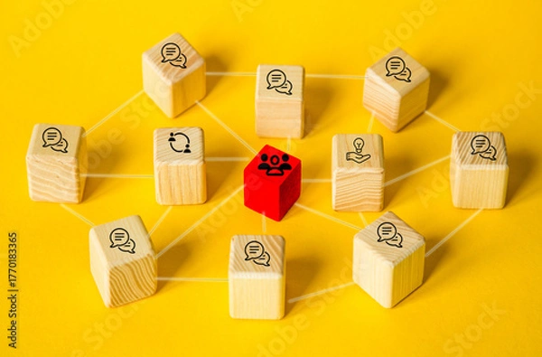 Fototapeta Teamwork and collaboration in business. work together with one's team members toward one's goal. Brainstorming for finding ideas. Cubes with network of employees and target goal icons on yellow