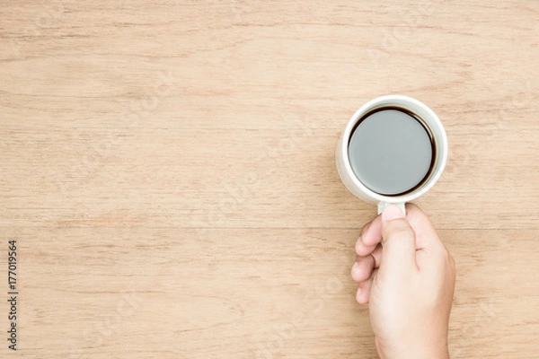 Obraz hold coffee cup on desk