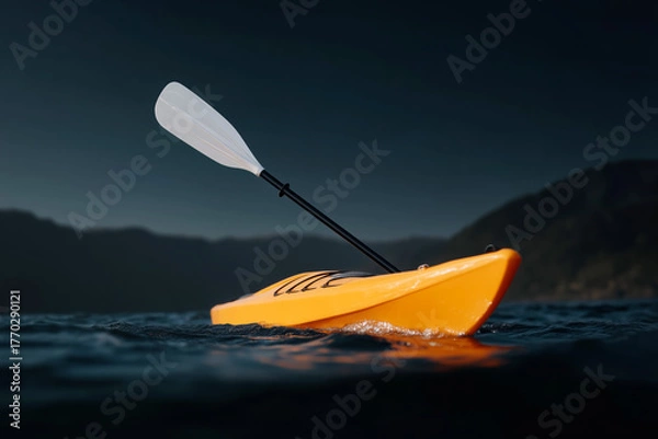 Fototapeta Bright yellow kayak with paddle floating on calm lake at dusk, adventure water sports in mountain landscape with dramatic dark sky